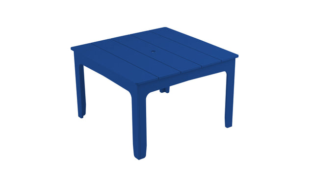 The Mainstay Square Dining Table by Ledge Lounger is a blue plastic dining table with four sturdy legs and a slatted surface, ideal for outdoor dining. It includes a built-in umbrella sleeve and is set against a plain white background.