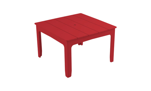 The Mainstay Square Dining Table by Ledge Lounger is a red plastic dining table with four straight legs and a simple slatted design. It features a central circular hole as an umbrella sleeve, making it lightweight and ideal for outdoor dining.