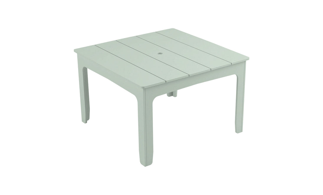 The Mainstay Square Dining Table by Ledge Lounger is a simple, square, white plastic outdoor table with four legs and a slatted top, featuring a built-in central umbrella sleeve—ideal for alfresco gatherings.