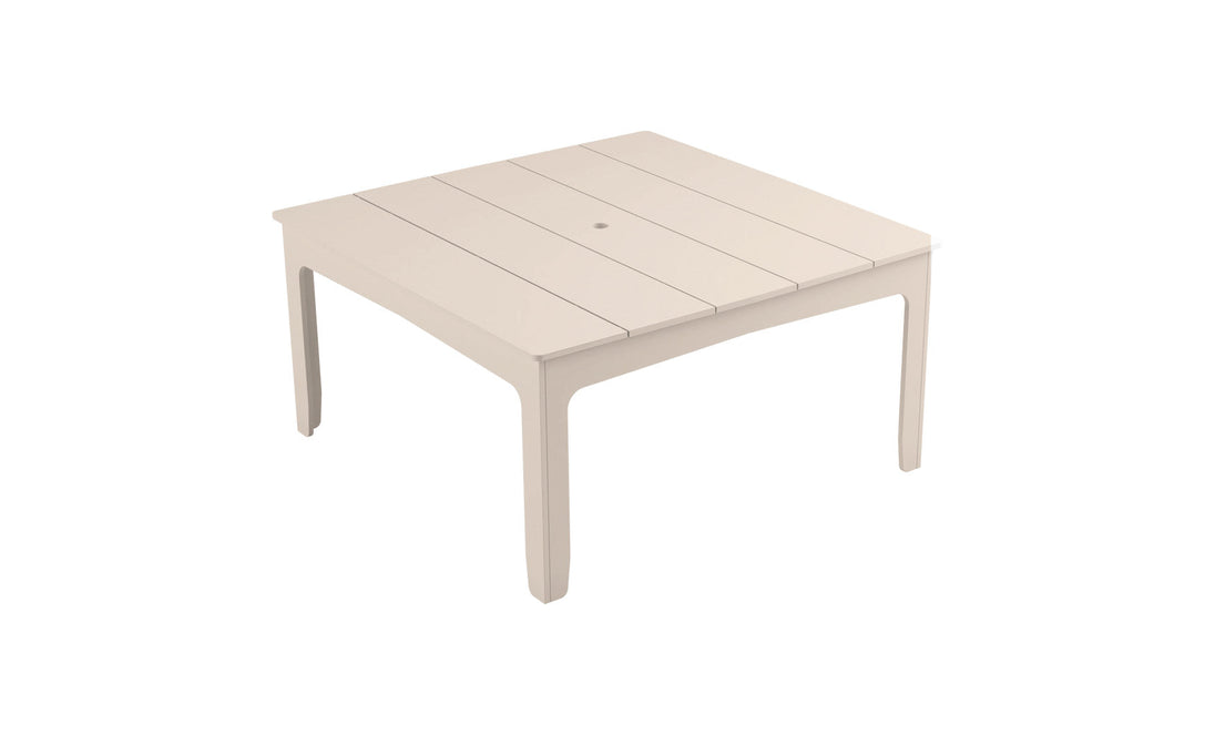 The Mainstay Square Dining Table by Ledge Lounger features a slatted tabletop design, a built-in umbrella sleeve, and four straight legs, making it perfect for outdoor dining.