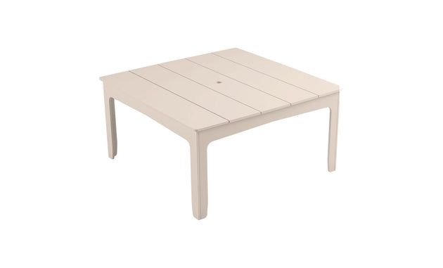 The Mainstay Square Dining Table by Ledge Lounger features a slatted tabletop design, a built-in umbrella sleeve, and four straight legs, making it perfect for outdoor dining.