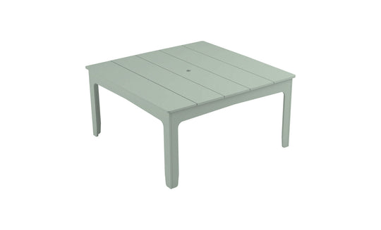 The Mainstay Square Dining Table by Ledge Lounger is a light green, plastic outdoor table with a slatted design, tapered legs, and a central hole with an umbrella sleeve, ideal for alfresco dining.