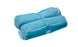 The Laze Hammock by Ledge Lounger is shown in turquoise with marine-grade fabrics. It has a textured finish, zippered pocket, and soft handle for easy carrying. Its compact design highlights functionality as it seamlessly blends into outdoor adventures while being neatly folded.