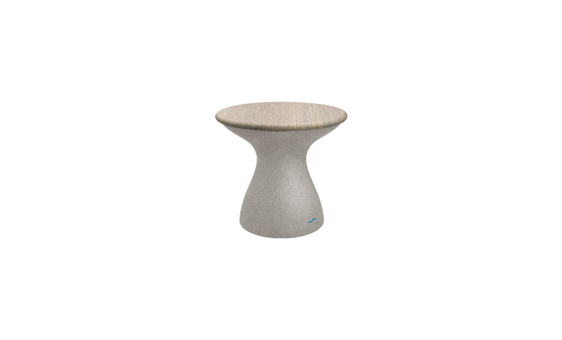 The Autograph Standard Side Table by Ledge Lounger features a modern hourglass design with a smooth light gray concrete finish and rounded top, ideal for contemporary interiors or as a chic outdoor side table by the pool.