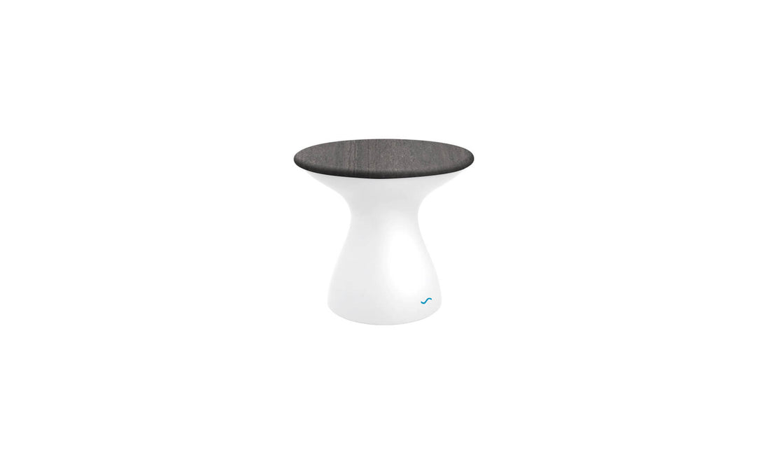 The Autograph Standard Side Table by Ledge Lounger is a modern piece with a sleek design, boasting a glossy white base and round dark wooden seat. Its minimalist hourglass shape perfectly suits outdoor use, blending style and function effortlessly.