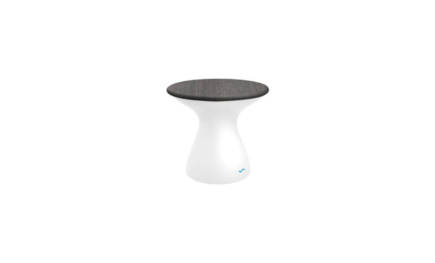 The Autograph Standard Side Table by Ledge Lounger is a modern piece with a sleek design, boasting a glossy white base and round dark wooden seat. Its minimalist hourglass shape perfectly suits outdoor use, blending style and function effortlessly.