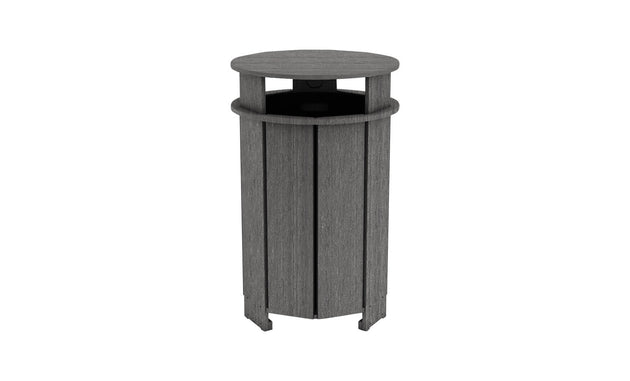 The Mainstay Trash Bin by Ledge Lounger is a tall, cylindrical wooden trash can with vertical planks. It features a dark gray finish and an open top for easy disposal.