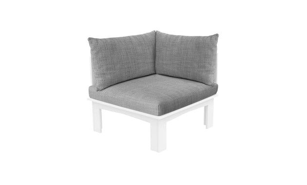 The Mainstay Sectional Relaxed Right Corner by Ledge Lounger, featuring white wooden legs and a soft light gray cushion set, enhances any space with its modern simplicity. Its textured fabric cushions add an elegant touch against a pristine white background.