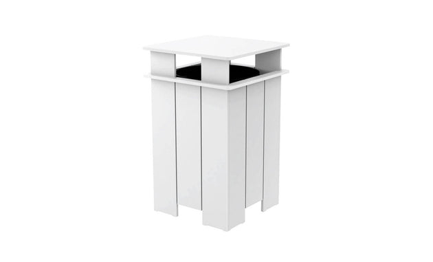 The Mainstay Trash Bin by Ledge Lounger is a modern, sleek white pedestal stand with a square top and open design, made from UV stable materials. Featuring vertical slats and a partially visible black circular object inside, its minimalist look suits contemporary indoor or patio decor.