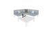 The Mainstay Sectional 4 Piece Diamond from Ledge Lounger in light blue forms a cozy corner with four cushions around a white square coffee table. The table features a wine bottle and two filled glasses, all set against a plain white background.