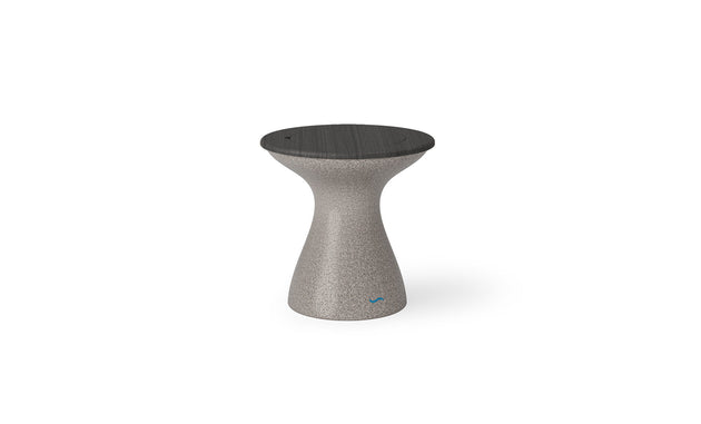 The Autograph Tall Ice Bin Side Table by Ledge Lounger features a modern hourglass shape with a smooth gray surface and a dark round top. Ideal as an outdoor side table, it stands out on a white background, showcasing its sleek and minimalist design.