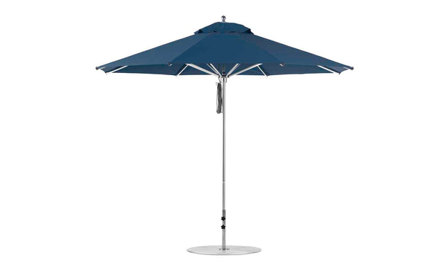 The Ledge Lounger Premier Aluminum Umbrella - 11 Octagon Pulley features a blue canopy and metal pole, showcasing its round shape. Made from marine-grade fabrics with multiple ribs, its designed to be wind resistant for outdoor use.