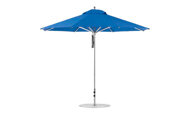The Premier Aluminum Umbrella - 11 Octagon Pulley by Ledge Lounger features a blue canopy with a white pole and circular base. Its fabric canopy is supported by multiple spokes, using marine-grade materials for wind resistance and durability in any outdoor setting.