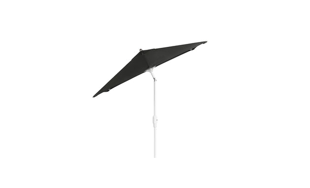 A dark green, triangular canopy parasol with a rustproof frame and angled white pole by Ledge Lounger. This 6.5 Square Signature 360° Tilt Umbrella is perfect for outdoor shade on sunny days, shown against a plain white background.