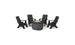 The Halo Aglow Bundle by Ledge Lounger features four black outdoor chairs encircling a round gray fire pit table adorned with decorative stones, set against a white background.