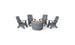 The Ledge Lounger Halo Aglow Bundle features a round outdoor fire pit table with a stone bowl and two candles, surrounded by four dark gray Adirondack chairs on a white background.