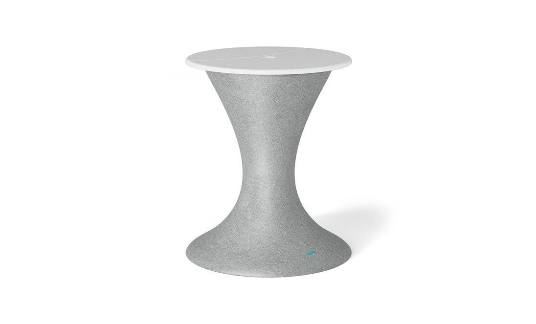 The Autograph Umbrella Stand Ice Bin by Ledge Lounger features a sleek hourglass design with a textured gray surface and smooth white round top, ideal as an indoor accent or innovative outdoor table, highlighting modern aesthetics.