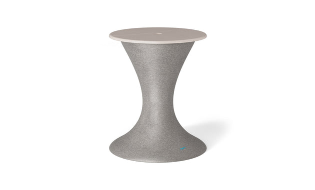 The Autograph Umbrella Stand Ice Bin by Ledge Lounger, featuring a tall, hourglass design with a gray speckled body and light beige top, serves as an elegant outdoor table or stool to enhance any patio setup.