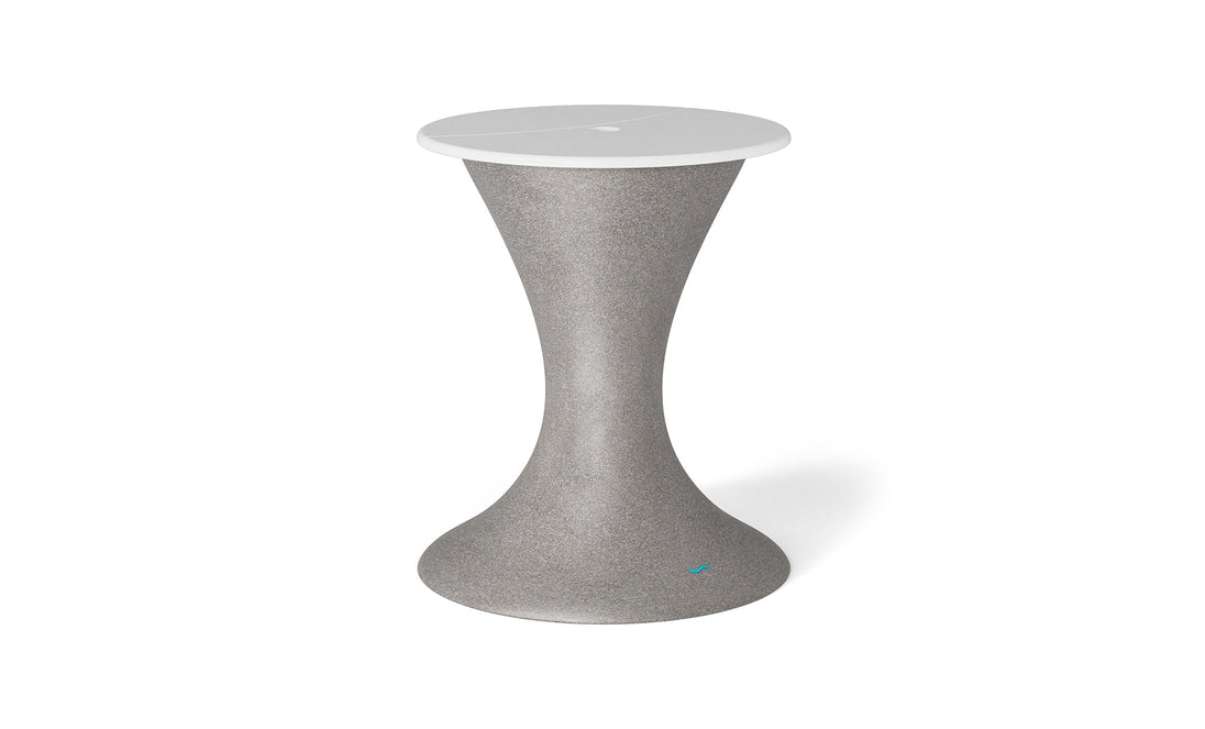 The Autograph Umbrella Stand Ice Bin by Ledge Lounger is a sleek, hourglass-shaped piece in gray with a white top, perfect as an outdoor table centerpiece. Its minimalist design offers style and functionality, standing out against a plain white backdrop.