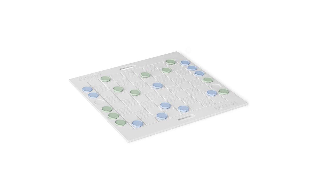 The Ledge Lounger Checkers & Tic Tac Toe board features a white checkered design with green and blue pieces. The grid pattern and side handles suggest a setup perfect for strategic abstract or giant lawn games.