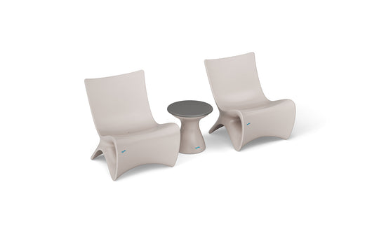 Two Classic Luxury In-Pool Chair Duos from Ledge Lounger in a minimalist beige with curved designs flank a small matching side table with a darker tabletop, exuding elegance and ideal for outdoor or patio use.