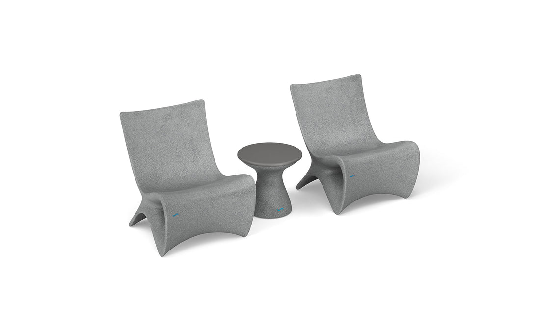 Two Classic Luxury In-Pool Chair Duo by Ledge Lounger and a matching round side table are set in a minimalist style. The chairs have a sleek, curved design, and the side table features a tapered base, all against a white background.
