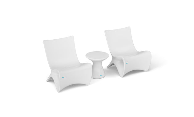 Two Classic Luxury In-Pool Chair Duo pieces by Ledge Lounger, with a small matching side table on a white background, showcase sleek, minimalist design and gentle curves—ideal for contemporary spaces.