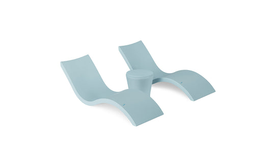 The Ledge Lounger Signature Chaise and Affinity Side Table In-Pool Set features two modern light blue chaise loungers with curved designs and a matching side table—perfect poolside essentials for relaxing in style against a white background.