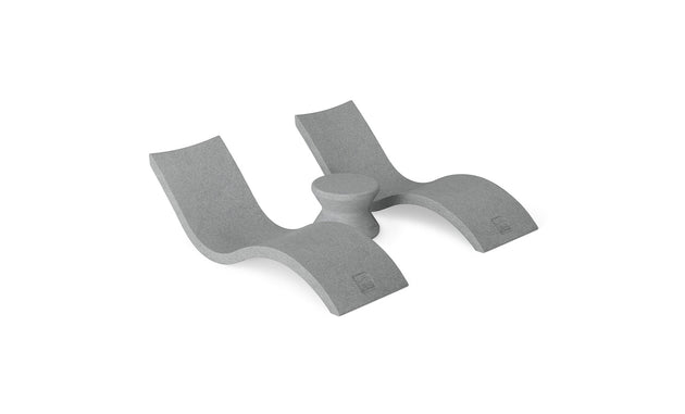 The Ledge Lounger Outdoor Oasis In-Pool Furniture Bundle includes a minimalist, gray L-shaped foam support with two curved sections and a central cylindrical part. Designed for ergonomic comfort and modern aesthetics, its perfect for adding style to your poolside essentials.
