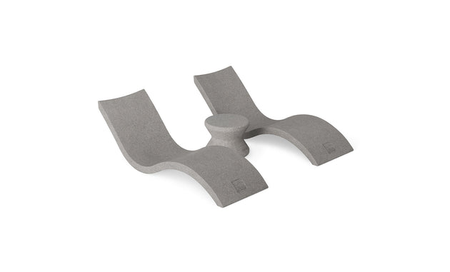 The Ledge Lounger Outdoor Oasis In-Pool Furniture Bundle features a gray, modern dual-seated chaise lounger with two curved platforms and a central support column, boasting smooth lines and a textured finish ideal for poolside essentials.