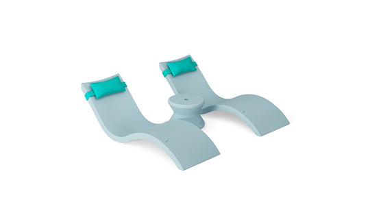 Transform your poolside with the Ledge Lounger Signature Chaise Headrest Pillow and Side Table In-Pool Set—featuring curved seats, turquoise pillows, and a central table—ideal for upgrading your pool ledge furniture.