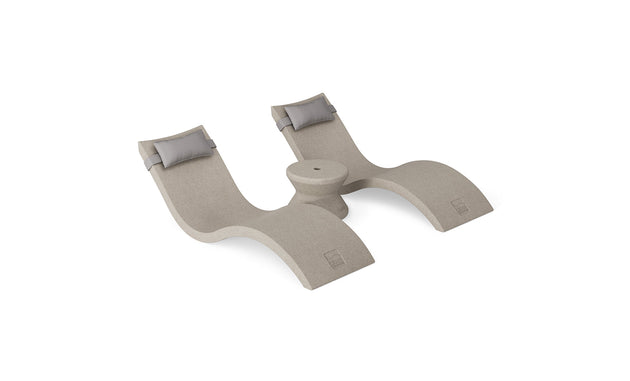 The Ledge Lounger Signature Chaise Headrest Pillow and Side Table In-Pool Set features two beige modern chaise loungers with gray headrests, joined by a round table, offering the ideal poolside seating against a white background.