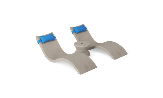 The Ledge Lounger Signature Chaise Headrest Pillow and Side Table In-Pool Set features two beige curved loungers with bright blue headrest pillows and a round side table, ideal for transforming your poolside into an outdoor paradise.
