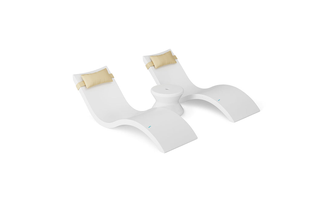 The Ledge Lounger Signature Chaise Headrest Pillow and Side Table In-Pool Set features two modern white lounge chairs with tan headrests, connected by a round side table—ideal for stylish poolside relaxation.