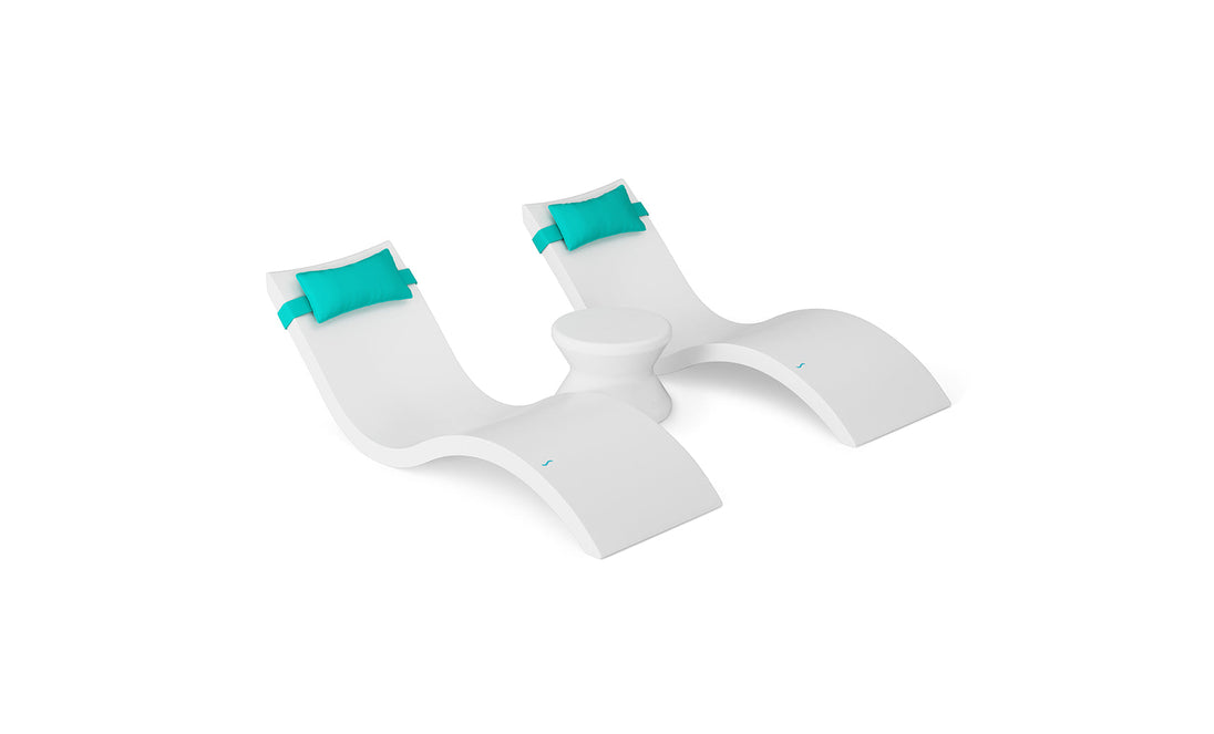 The Ledge Lounger Signature Chaise Headrest Pillow and Side Table In-Pool Set, featuring two modern white loungers with curved lines, turquoise headrests, and a connecting round table, creates the ideal poolside retreat against a white background.