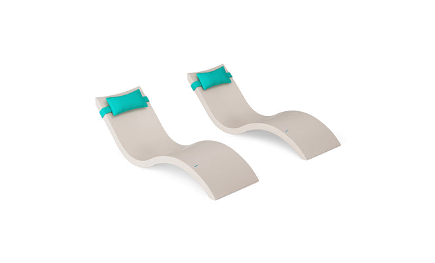 The Ledge Lounger Signature Chaise and Headrest Pillow In-Pool Set features two modern beige, S-shaped chaise lounges with teal headrest pillows, ideal for elevating your outdoor furniture style against a clean white backdrop.