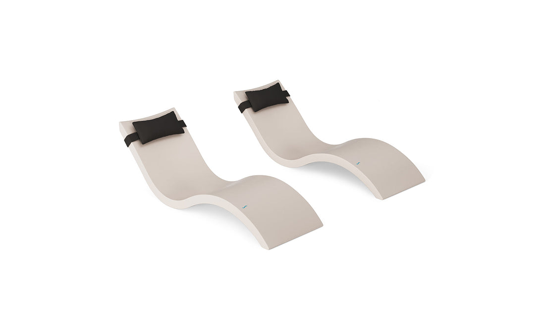 The Ledge Lounger Signature Chaise and Headrest Pillow In-Pool Set features two modern beige chaises with black headrest pillows, side by side on a white background—ideal as stylish outdoor patio furniture.