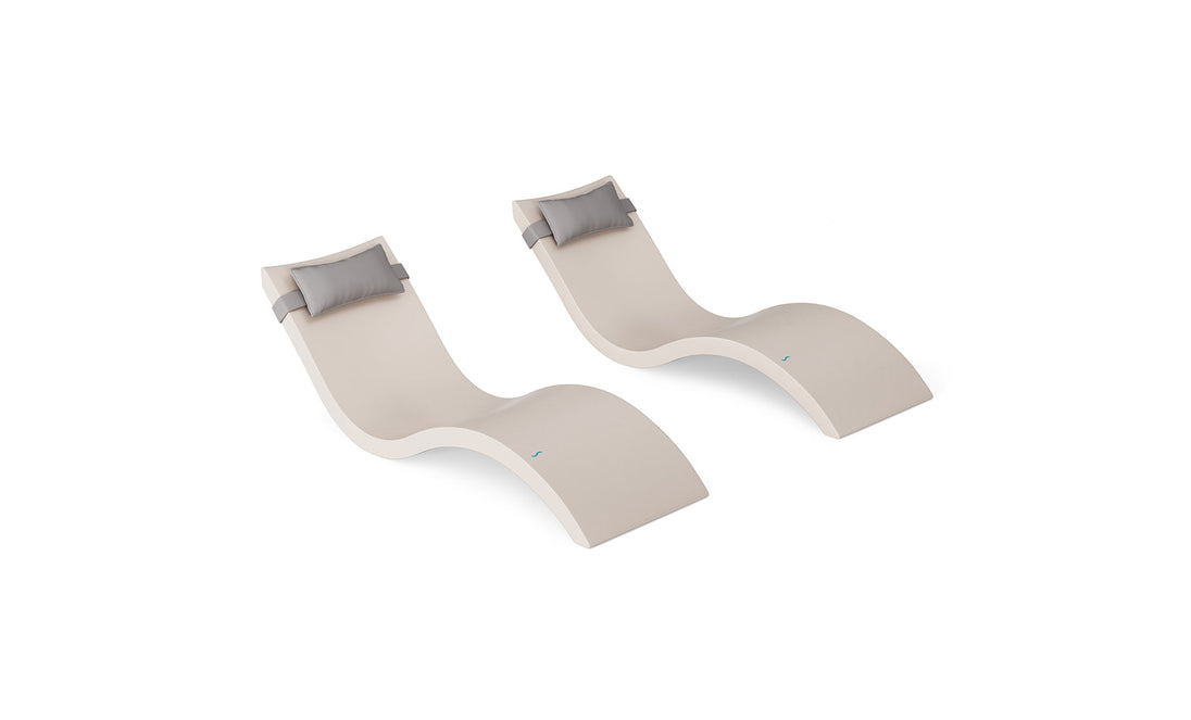 The Ledge Lounger Signature Chaise and Headrest Pillow In-Pool Set includes two modern beige wave-shaped chaises with gray pillows, side by side on a white background—ideal for stylish outdoor furniture.
