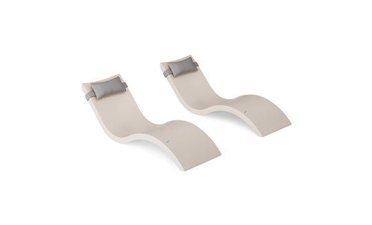 The Ledge Lounger Signature Chaise and Headrest Pillow In-Pool Set includes two modern beige wave-shaped chaises with gray pillows, side by side on a white background—ideal for stylish outdoor furniture.