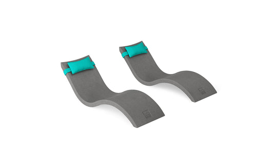 The Ledge Lounger Signature Chaise and Headrest Pillow In-Pool Set features two modern, curved gray loungers with teal pillows, side by side on a white background—ideal for creating a perfect outdoor escape.