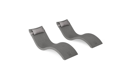 The Ledge Lounger Signature Chaise and Headrest Pillow In-Pool Set features two modern gray wave-shaped lounges, placed side by side, creating the perfect outdoor escape.