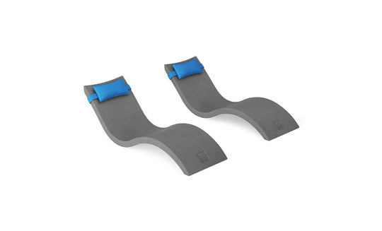 The Ledge Lounger Signature Chaise and Headrest Pillow In-Pool Set includes two gray, wave-shaped chaise lounges with blue headrest pillows, side by side on a white background—ideal for your outdoor escape.