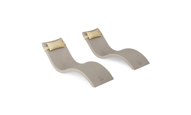 Two modern, curved beige Ledge Lounger Signature Chaise and Headrest Pillow In-Pool Sets are displayed on a white background, each featuring an attached yellow pillow.