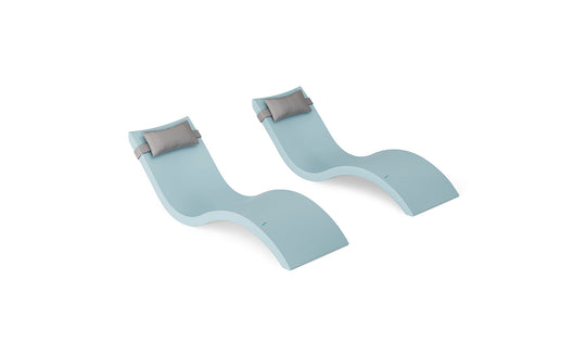 The Ledge Lounger Signature Chaise and Headrest Pillow In-Pool Set features two modern, light blue loungers with curved shapes and attached pillows, side by side on a white background—ideal for your outdoor retreat.