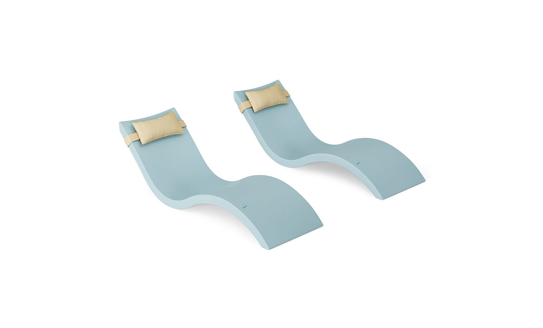 The Ledge Lounger Signature Chaise and Headrest Pillow In-Pool Set features two light blue chaise lounges with beige headrest pillows, arranged side by side on a white background for a perfect outdoor escape.