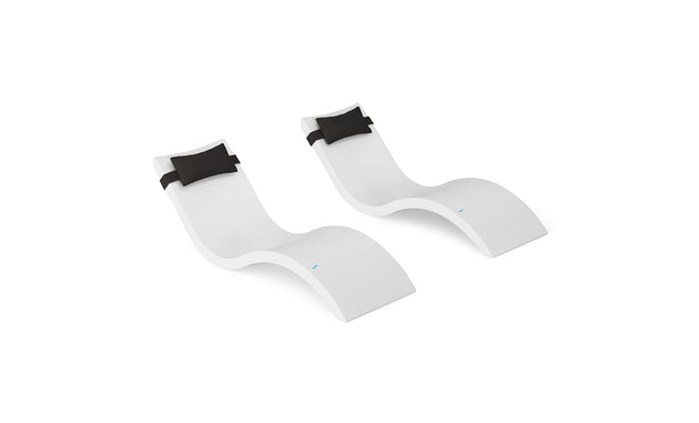 The Ledge Lounger Signature Chaise and Headrest Pillow In-Pool Set features two sleek white chaise lounges with black pillows, shown side by side on a white background—an elegant upgrade to any outdoor space.