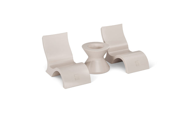 Ledge Loungers Relaxation In-Pool Chair & Ice Bin Bundle features three minimalist beige pieces: two ergonomic curved chairs and an hourglass table. Their smooth, modern design makes them perfect poolside essentials for a chic outdoor retreat.