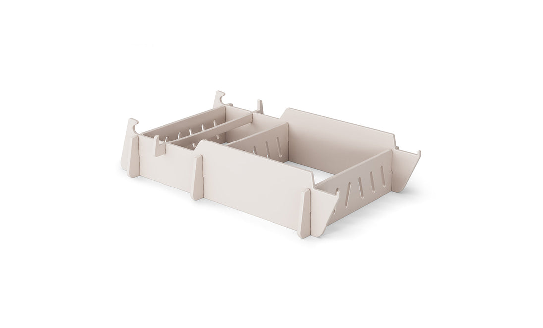 A stylish, beige drawer organizer with adjustable sections and slotted edges for custom compartments, reminiscent of a Signature Lowback Chair Riser by Ledge Lounger, rests elegantly on a plain white background.
