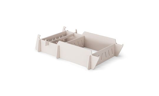 A stylish, beige drawer organizer with adjustable sections and slotted edges for custom compartments, reminiscent of a Signature Lowback Chair Riser by Ledge Lounger, rests elegantly on a plain white background.