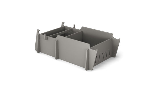 The Ledge Lounger Signature Lowback Chair Riser is a gray modular storage box with three compartments and detachable panels. It features side slots for ventilation, an interlocking system for stacking, and is perfect for outdoor use or by pool seats, set against a plain white background.